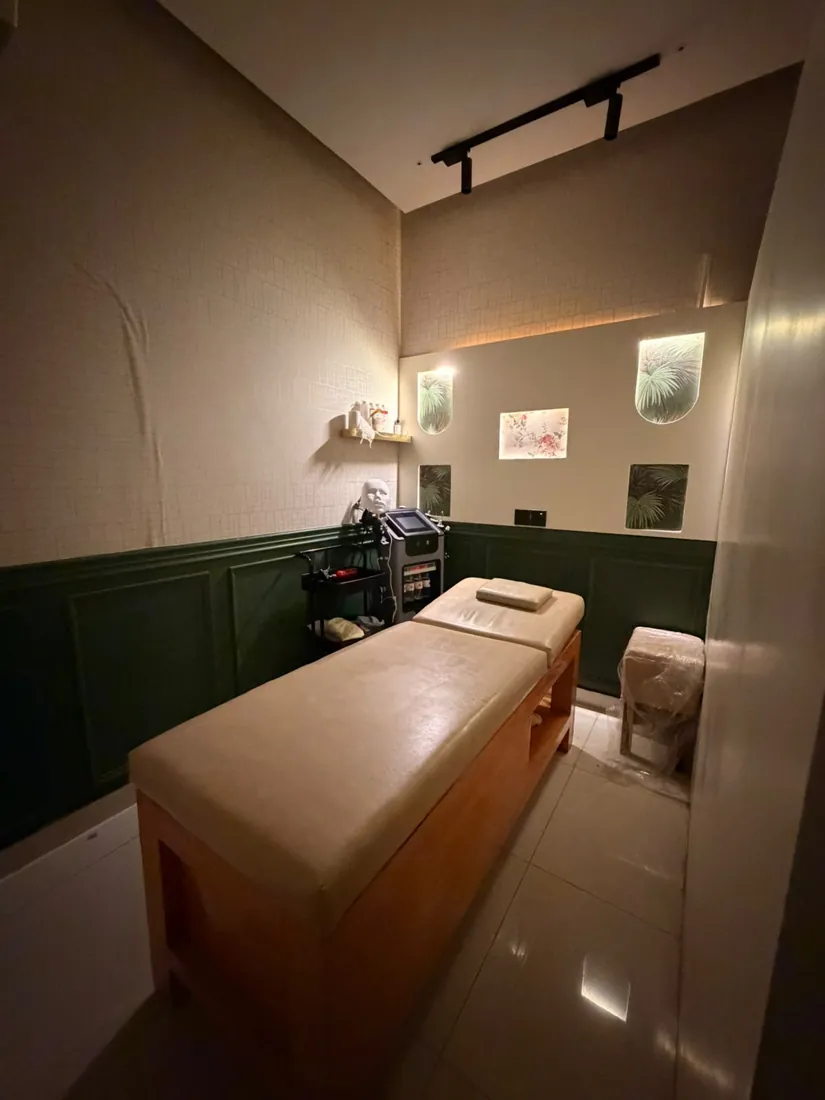 Calm treatment room with massage bed