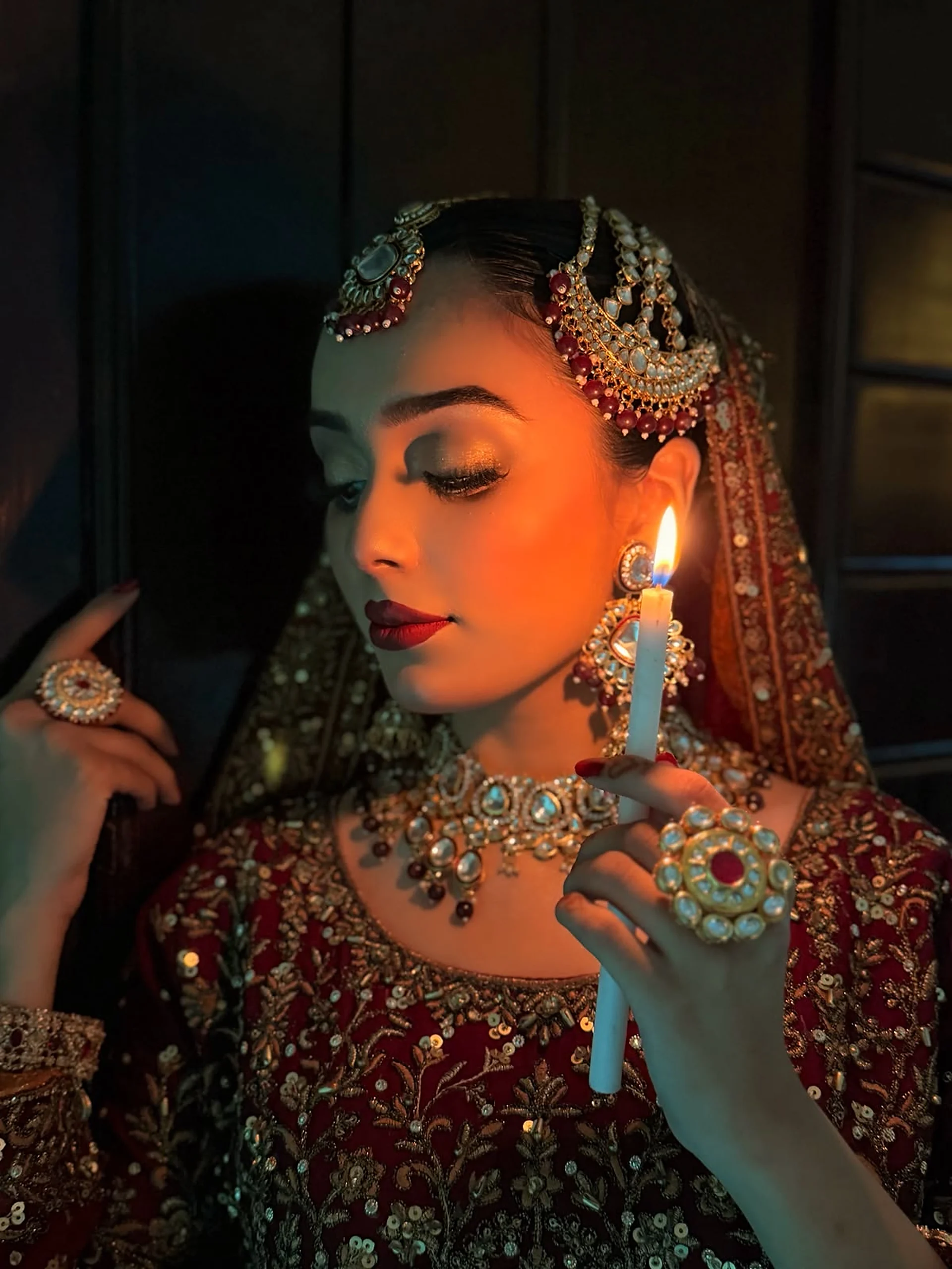 Bride with traditional red and gold bridal makeup by Areeba Ainee Beauty Lounge
