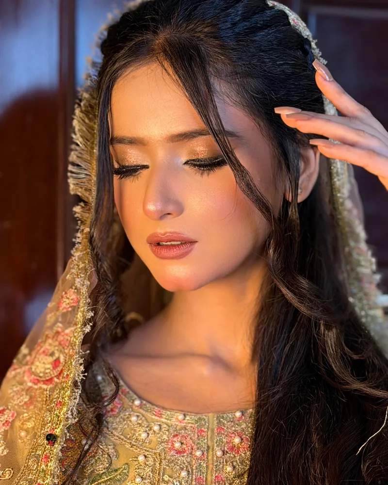 Signature bridal makeup with golden eyes and dewy skin