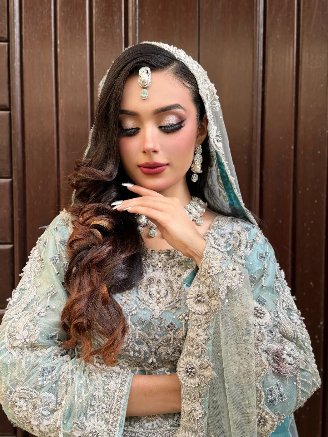 Bride in pastel blue bridal wear with soft glam makeup
